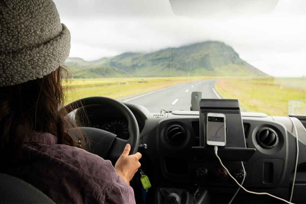 uma mulher dirigindo um carro alugado para seu destino desejado para seguir viagem 